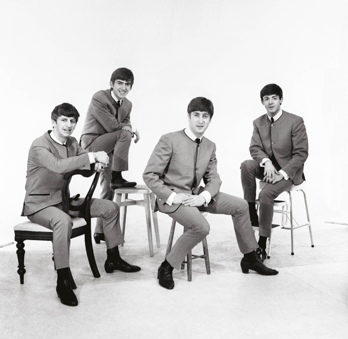 A photo of the Beatles in the 'With the Beatles' time period, wearing the tailored suits Epstein arranged for them. Original source: The Beatles - 1962-1966 (tidal.com), tidal.com/magazine/article/the-beatles-1962-1966/1-20464.